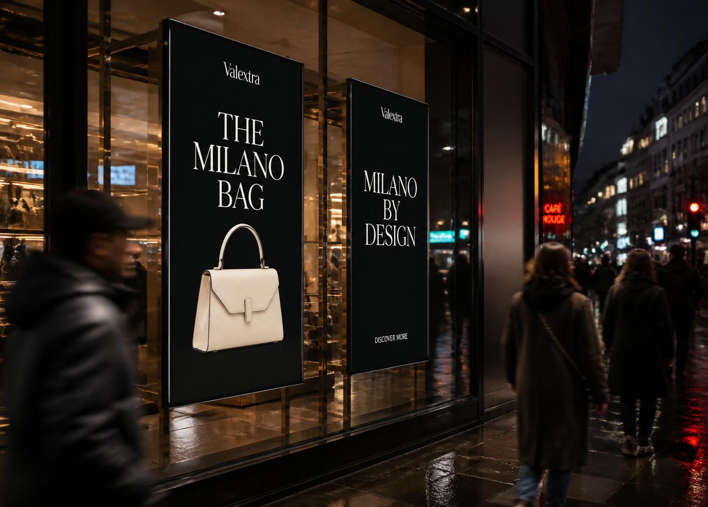 Luxury retail shop window at night with portrait digital displays running a fashion campaign, pedestrians walking past.